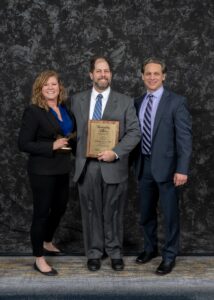 Faith Taylor and Jason Manni receive award from Butler